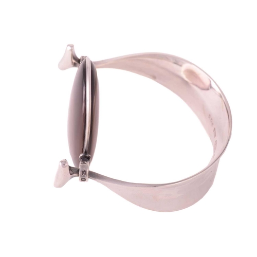 327 - Georg Jensen - 'Arm Ring' with smokey quartz, a tension clamp opening bangle with an oval panel of p... 