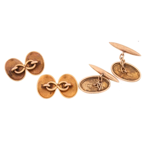 33 - Two pairs of gold cufflinks; a plain oval pair with English hallmarks for 15ct gold and an engraved ... 