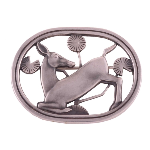 334 - Georg Jensen - a brooch depicting a kneeling fawn and flowers, fitted with hinged pin stem and roll-... 