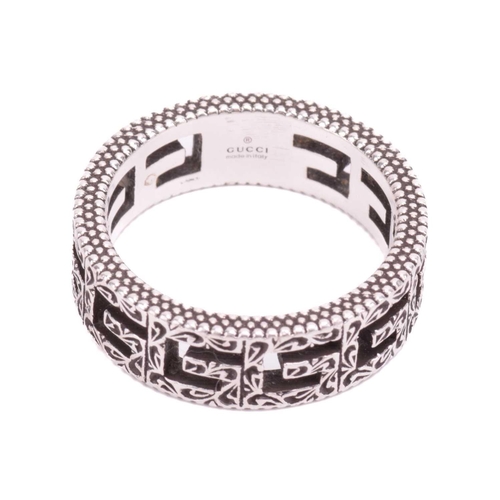 36 - Gucci - a silver ring in 'Square G' cut-out design, embellished with Arabesque-style engravings and ... 