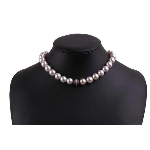 42 - A South Sea pearl necklace with a spherical diamond and pink sapphire clasp, the pearls measuring 13... 