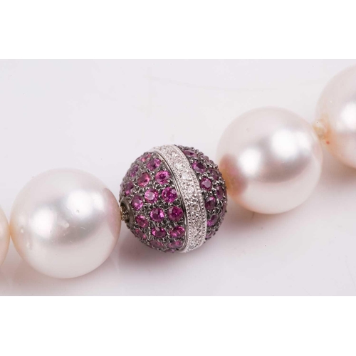 42 - A South Sea pearl necklace with a spherical diamond and pink sapphire clasp, the pearls measuring 13... 