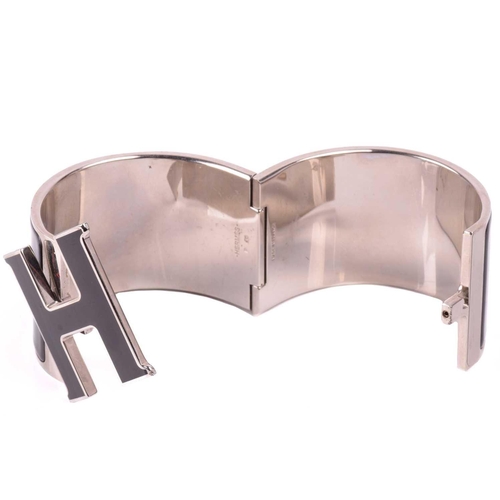 44 - Hermès - an extra wide 'Clic Clac H' bracelet with black enamel and white-toned metal, signed and ma... 