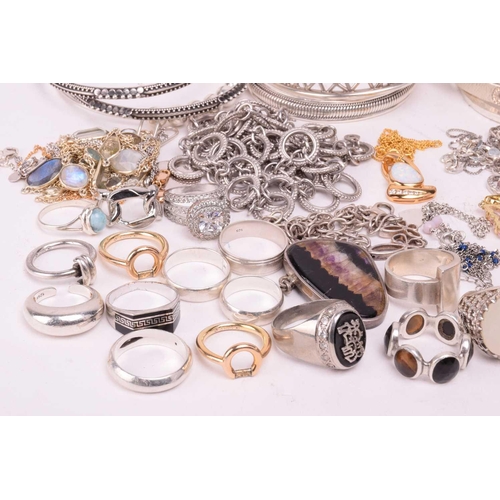 37 - A collection of white metal jewellery including various bangles, bracelets, rings and necklaces with... 