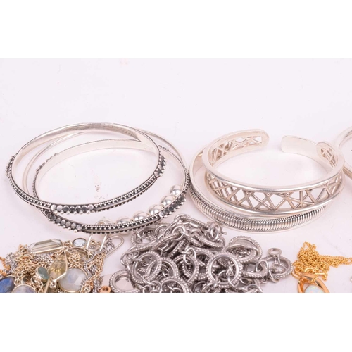 37 - A collection of white metal jewellery including various bangles, bracelets, rings and necklaces with... 