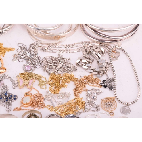 37 - A collection of white metal jewellery including various bangles, bracelets, rings and necklaces with... 