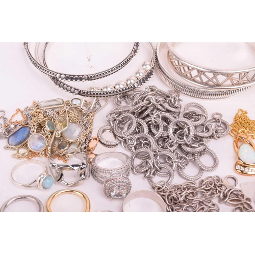 37 - A collection of white metal jewellery including various bangles, bracelets, rings and necklaces with... 