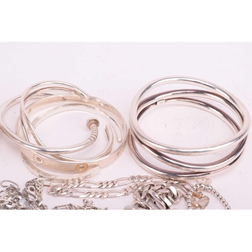 37 - A collection of white metal jewellery including various bangles, bracelets, rings and necklaces with... 