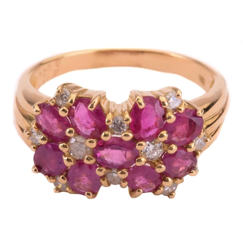 46 - A ruby and diamond cluster ring, set with oval rubies and round brilliant cut diamonds, the shank st... 