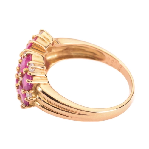 46 - A ruby and diamond cluster ring, set with oval rubies and round brilliant cut diamonds, the shank st... 