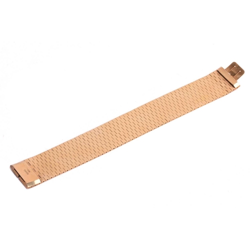 49 - An 18ct gold bracelet circa 1960s, formed of flat textured brick links forming an articulated ribbon... 