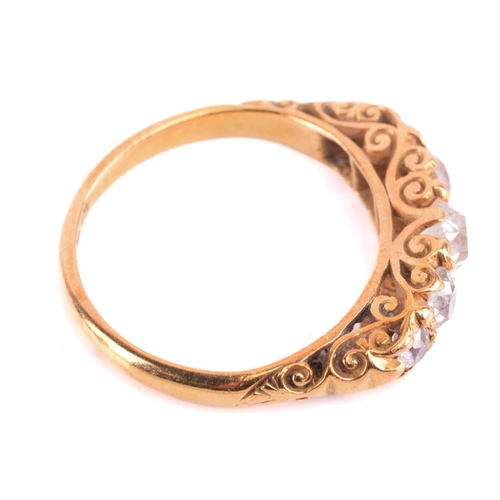 5 - A Victorian diamond five-stone carved half hoop ring, circa 1898, set with a row of cushion shape ol... 