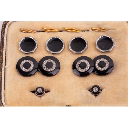 55 - An onyx and diamond dress set comprised of a pair of cufflinks, two dress studs and four buttons, in... 