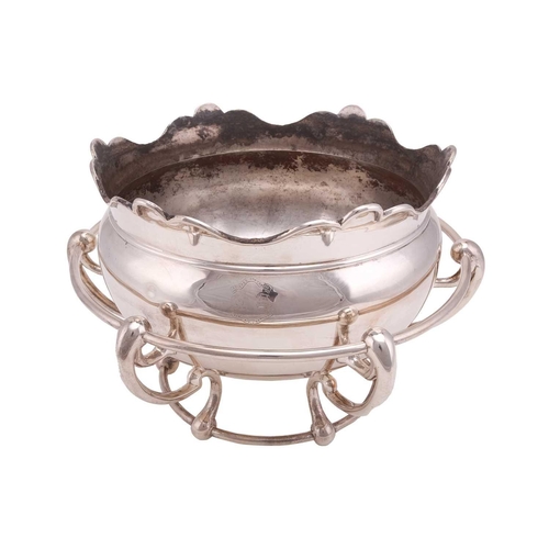 575 - An Art Nouveau punch bowl sitting within an integrated frame. The circular Monteith style bowl with ... 