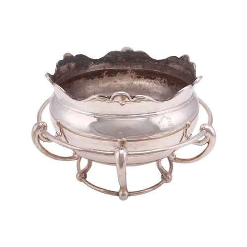 575 - An Art Nouveau punch bowl sitting within an integrated frame. The circular Monteith style bowl with ... 