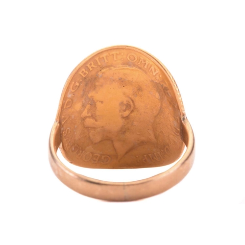 60 - A George V half-sovereign bent-over ring, the surface has been polished off, with the bare head of G... 