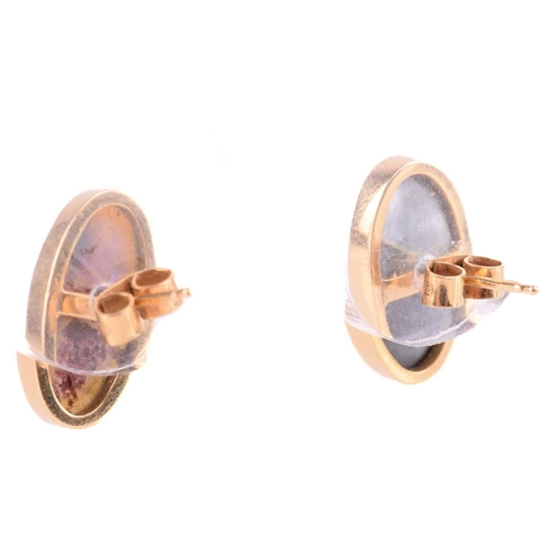 61 - A pair of black opal stud earrings in 18ct yellow gold, one of the oval cabochons is a boulder opal ... 