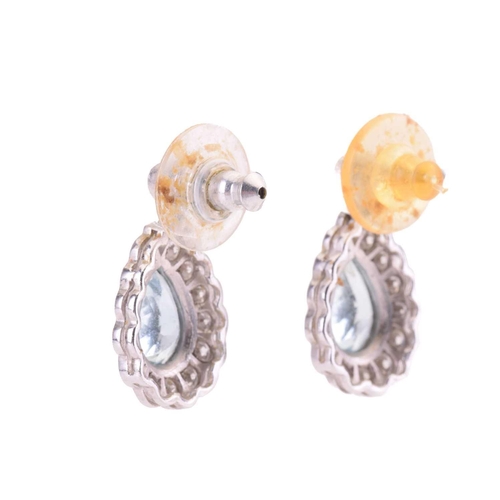 63 - A pair of aquamarine and diamond pendant earrings, each set with a pear shape aquamarine surrounded ... 