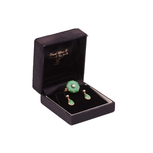 64 - A jade and diamond dress ring; the circular jadeite bi disc of bright green colour, set with a centr... 