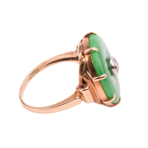 64 - A jade and diamond dress ring; the circular jadeite bi disc of bright green colour, set with a centr... 