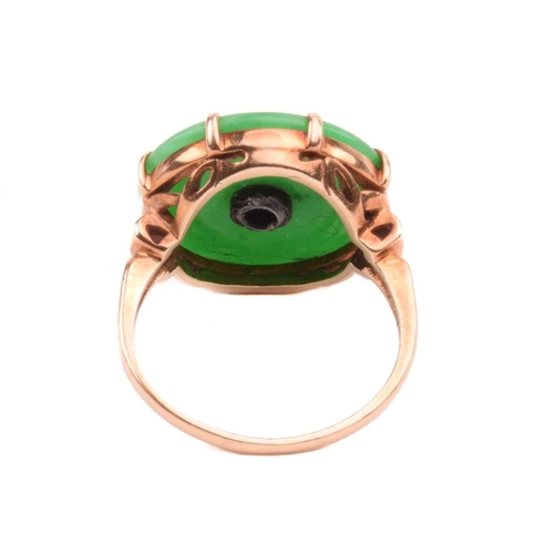 64 - A jade and diamond dress ring; the circular jadeite bi disc of bright green colour, set with a centr... 