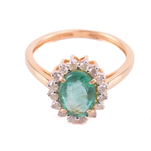 66 - An emerald and diamond halo ring, centred with an oval-cut emerald of pale green colour, approximate... 