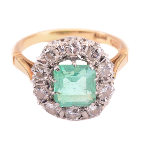 7 - An emerald and diamond cluster ring; the central rectangular step-cut emerald measuring approximatel... 