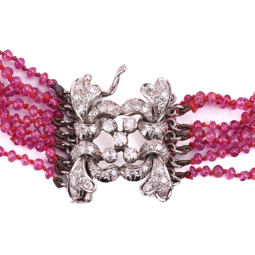 74 - A ruby bead bracelet with a diamond-set clasp, comprising eight rows of spherical ruby beads of 2.0 ... 