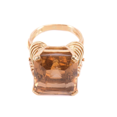 75 - A single stone citrine dress ring, the large rectangular mixed cut, cut-cornered citrine in ribbed c... 