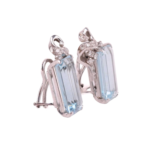 76 - A pair of aquamarine and diamond ear clips, the emerald-cut aquamarines measure approximately 18.00 ... 