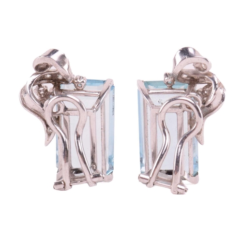 76 - A pair of aquamarine and diamond ear clips, the emerald-cut aquamarines measure approximately 18.00 ... 