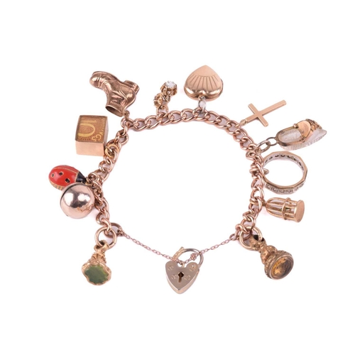 78 - A charm bracelet in 9ct rose gold, consisting of a curb link chain, suspending with a collection of ... 