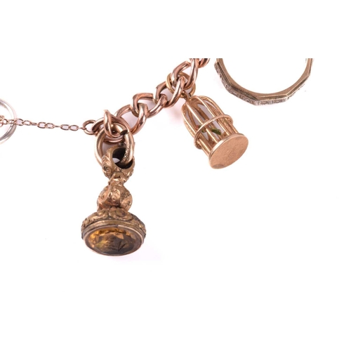 78 - A charm bracelet in 9ct rose gold, consisting of a curb link chain, suspending with a collection of ... 