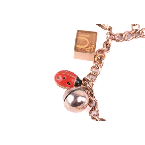 78 - A charm bracelet in 9ct rose gold, consisting of a curb link chain, suspending with a collection of ... 