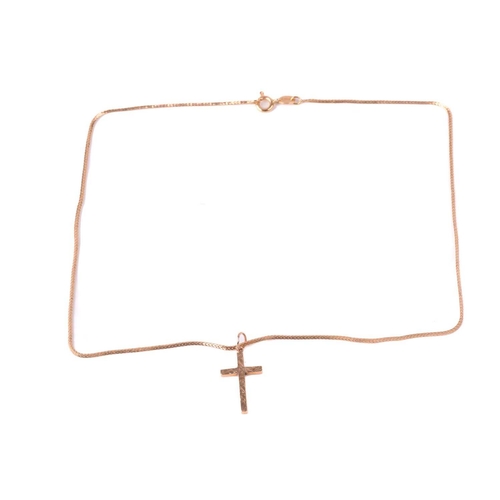 81 - A gold cross with hallmarks for 9ct gold, with a foxtail chain marked 750 measuring 40.5cm in length... 