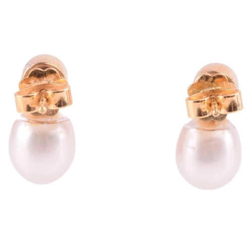 82 - A pair of cultured pearl and diamond earrings in yellow gold, each set with a round brilliant cut di... 