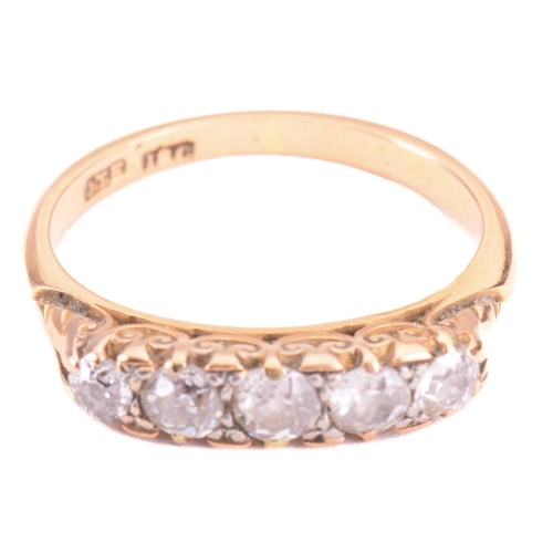 9 - A diamond five stone carved half hoop ring, set with a graduated row of old cut diamonds with a tota... 