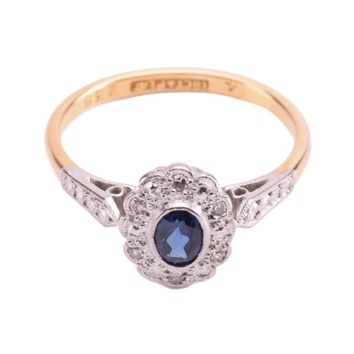 92 - A sapphire and diamond cluster ring, set with an oval sapphire measuring 4.9 x 3.6 x 2.7mm, encircle... 