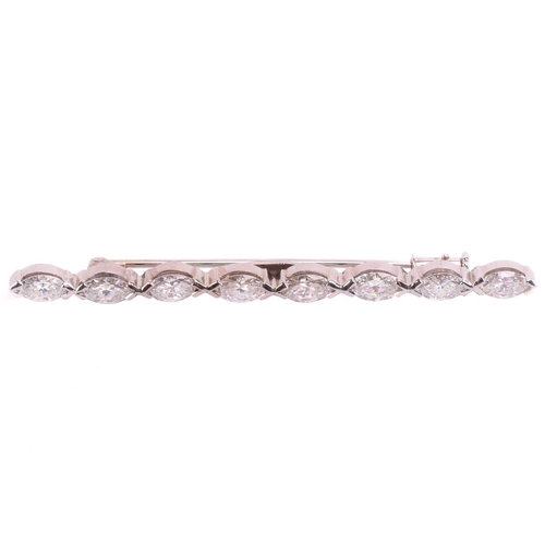 99 - A diamond bar brooch, elegantly set with a row of eight marquise shape diamonds with a total estimat... 