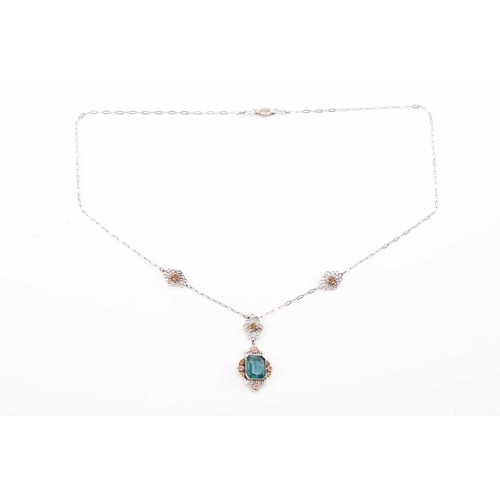 112 - An American fine pendant necklace, the pendant set with a blue-green paste within a dainty tri-colou... 