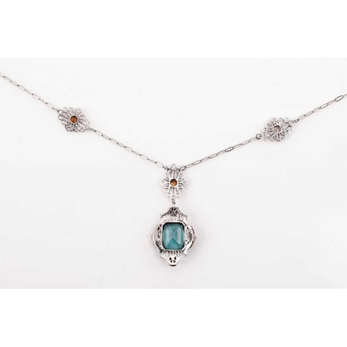 112 - An American fine pendant necklace, the pendant set with a blue-green paste within a dainty tri-colou... 