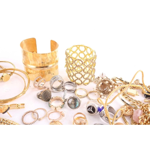 115 - A large quantity of assorted base metal jewellery, including examples of yellow-toned necklaces, ban... 