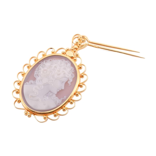 116 - A hardstone cameo pendant featuring a profile of a lady, the filigree frame marked '750' and 'k.22',... 
