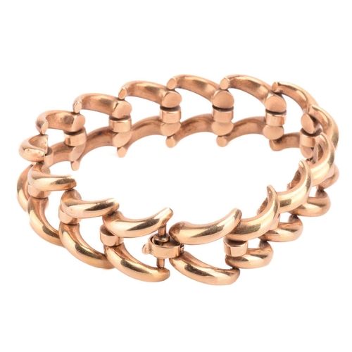 119 - A chevron link bracelet, connected with hinges and fastened with a fold-over clasp, yellow metal str... 