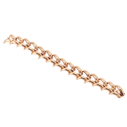 119 - A chevron link bracelet, connected with hinges and fastened with a fold-over clasp, yellow metal str... 