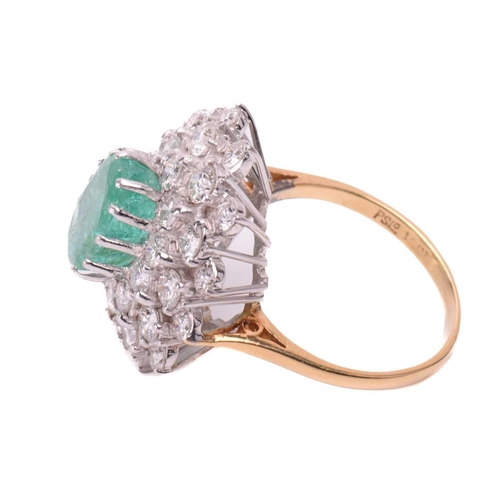 32 - An emerald and diamond cluster ring, the fracture-filled emerald centrally set within a cluster of r... 