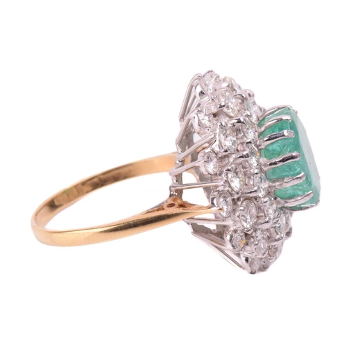 32 - An emerald and diamond cluster ring, the fracture-filled emerald centrally set within a cluster of r... 