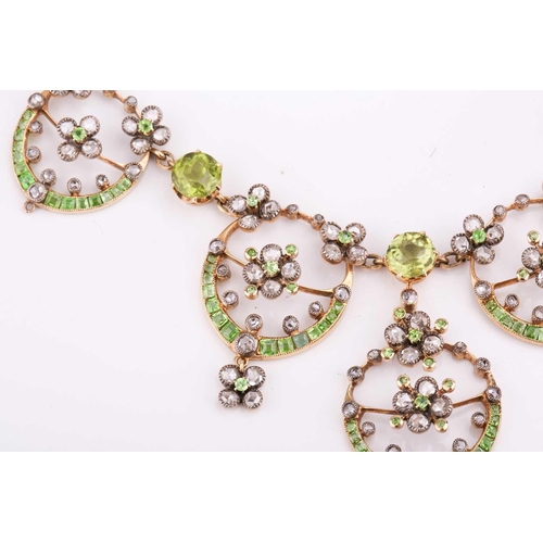48 - An Edwardian diamond, peridot and demantoid garnet necklace, circa 1910, the floral garland design s... 