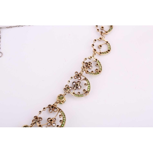 48 - An Edwardian diamond, peridot and demantoid garnet necklace, circa 1910, the floral garland design s... 