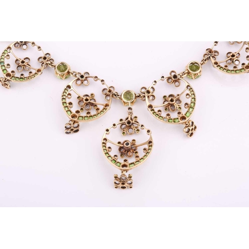 48 - An Edwardian diamond, peridot and demantoid garnet necklace, circa 1910, the floral garland design s... 